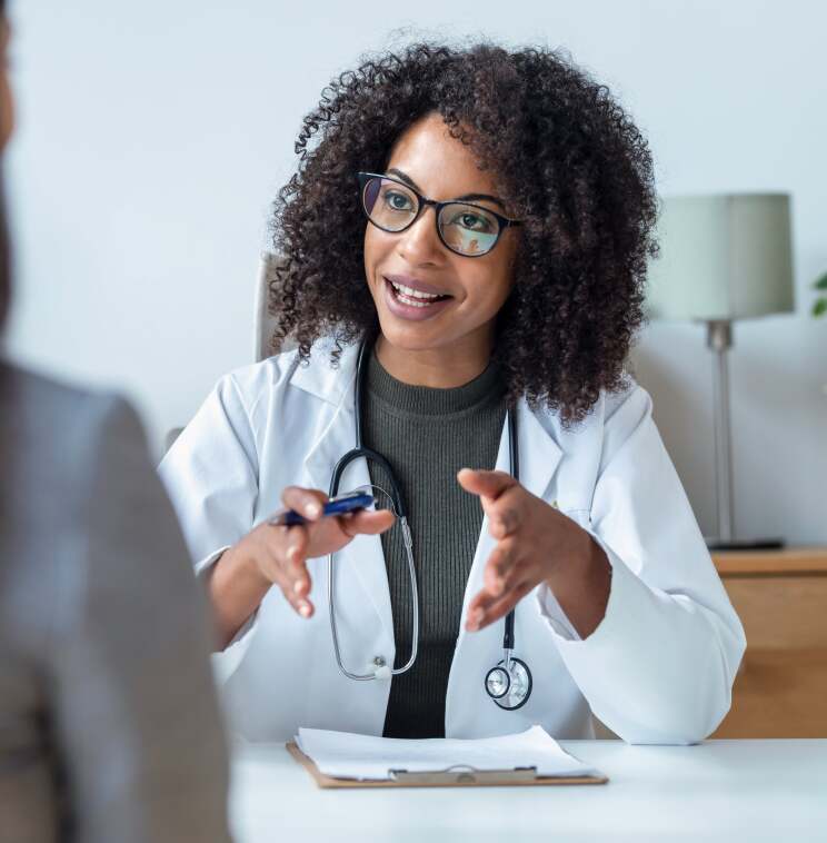Fertility doctor speaking with a patient during a consultation