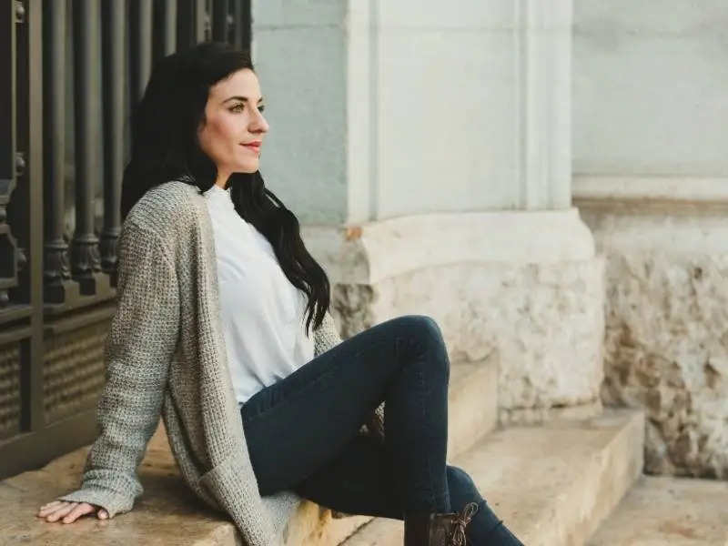 Woman sitting outdoors during her period