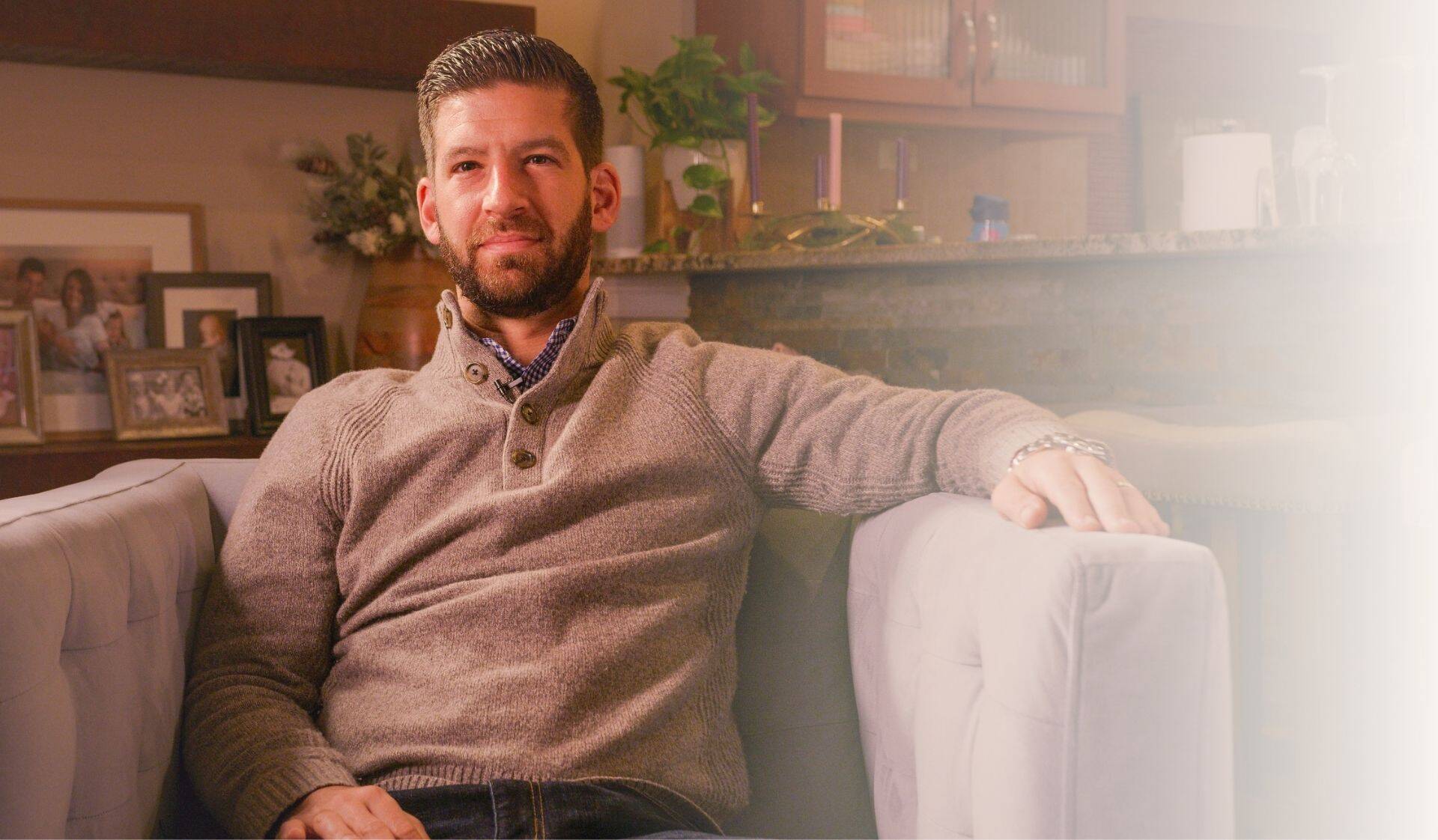 Man sitting at home representing male infertility and reproductive health