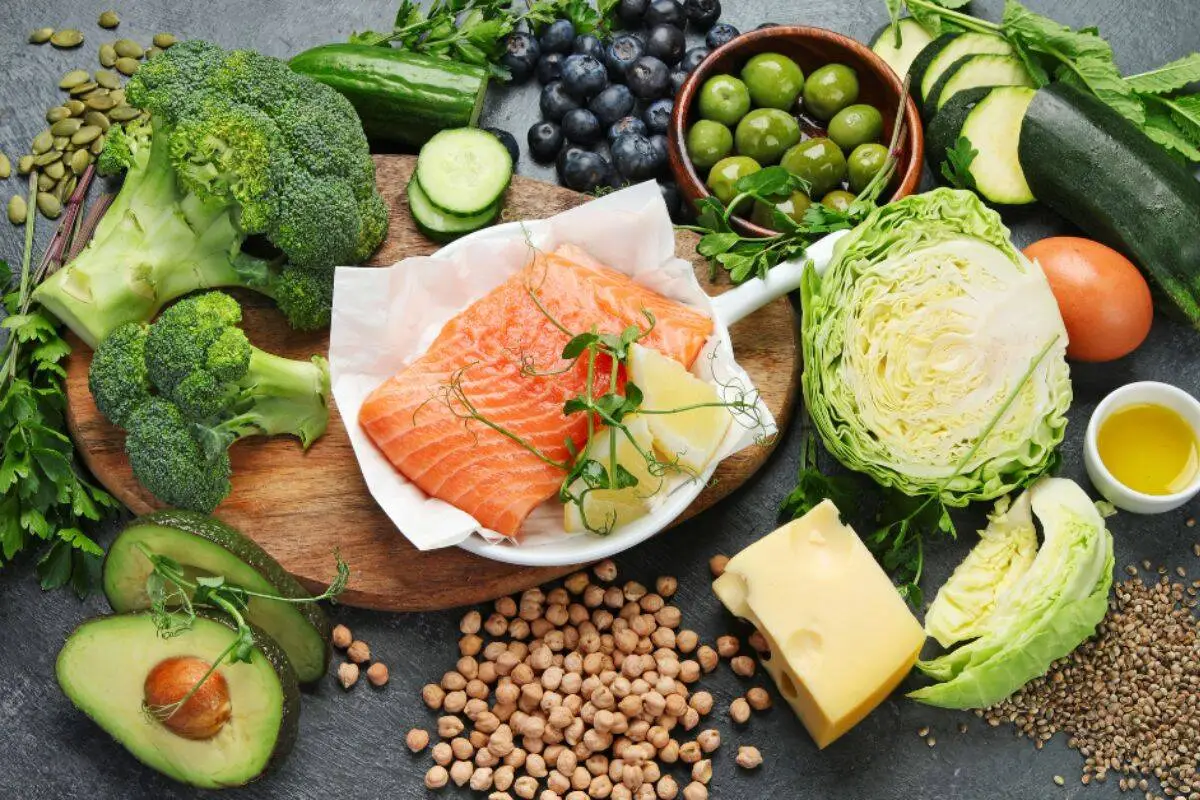 Mediterranean diet foods including salmon, vegetables, avocado, olives, and legumes